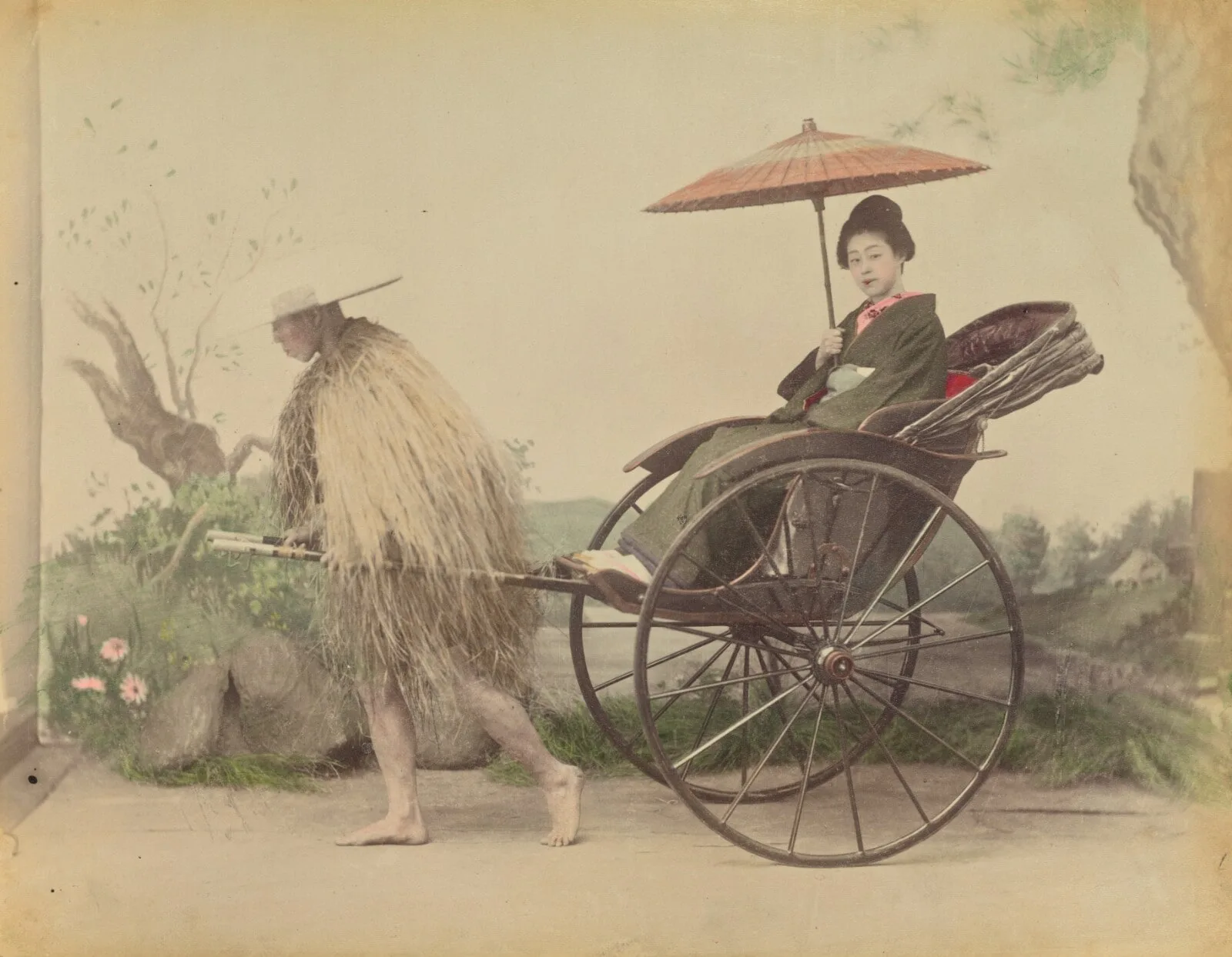 [Woman with Parasol Posed Being Pulled in a Jinrikisha by a Man Wearing a Straw Rain Coat]